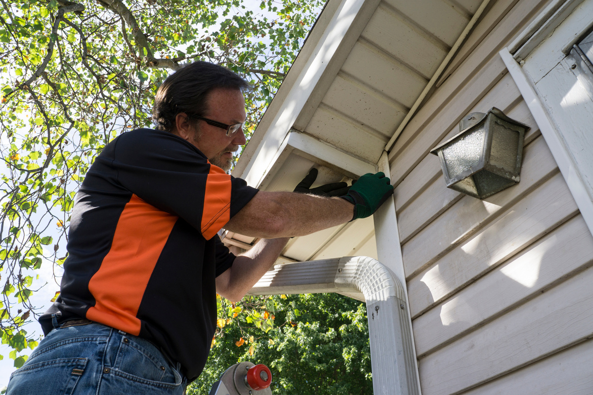 Contractor Fixing Vinyl Siding For Customer